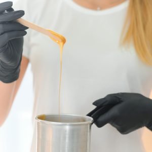 female-cosmetologist-holding-stick-with-wax-for-de-2025-03-14-04-25-11-utc (1) (1)